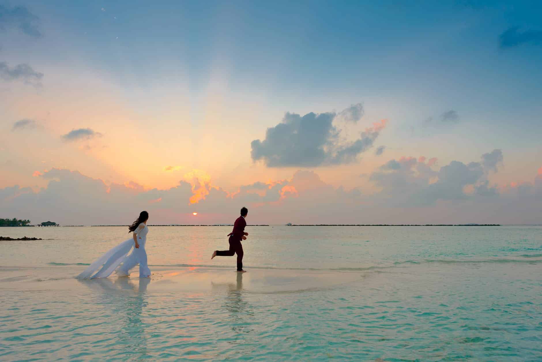 man and woman standing at seashore